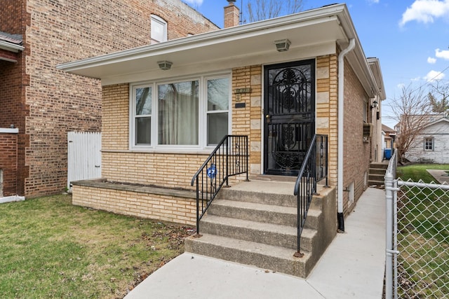 733 E 90th St, Chicago, IL 60619 - property entrance featuring brick siding and a chimney
