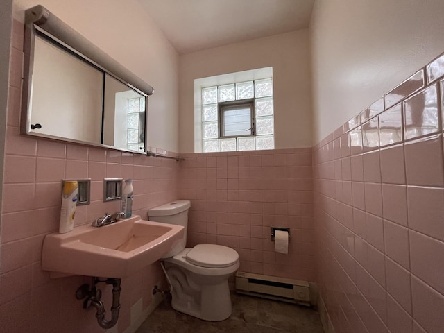 733 E 90th St, Chicago, IL 60619 - half bathroom with baseboard heating, tile walls, toilet, wainscoting, and a sink