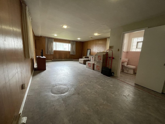 733 E 90th St, Chicago, IL 60619 - below grade area with wooden walls and a baseboard radiator