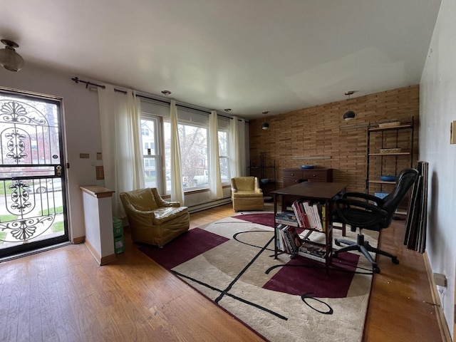 733 E 90th St, Chicago, IL 60619 - living area with a baseboard heating unit, light wood-style floors, baseboards, and a desk
