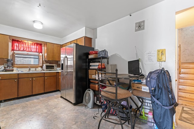 733 E 90th St, Chicago, IL 60619 - kitchen featuring stainless steel refrigerator with ice dispenser, brown cabinets, a sink, and light countertops