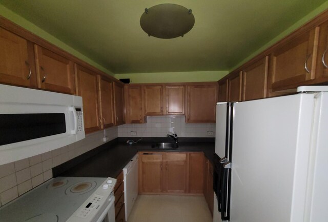 4800 S Chicago Beach Dr Unit 1814N, Chicago, IL 60615 - kitchen with white appliances, brown cabinetry, backsplash, and dark countertops