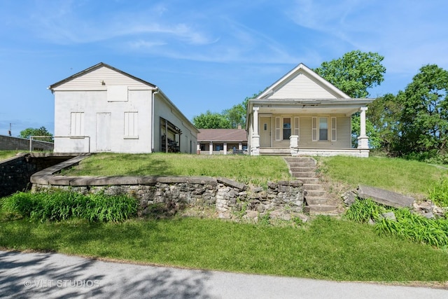 view of front of home with covered porch and a front yard