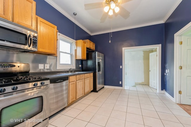 kitchen with appliances with stainless steel finishes, ceiling fan, dark countertops, crown molding, and baseboards