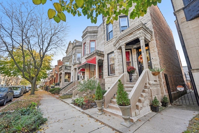 4914 S Washington Park Ct, Chicago, IL 60615 - townhome / multi-family property with stone siding, a residential view, and a gate