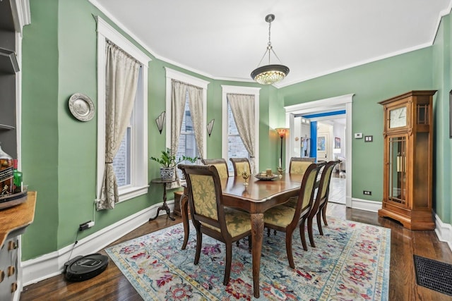 4914 S Washington Park Ct, Chicago, IL 60615 - dining space featuring crown molding, wood finished floors, and baseboards