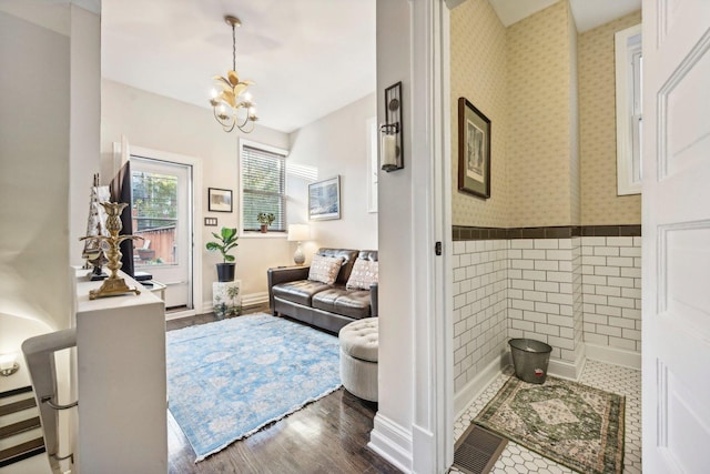 4914 S Washington Park Ct, Chicago, IL 60615 - living area featuring a chandelier, wood finished floors, and baseboards