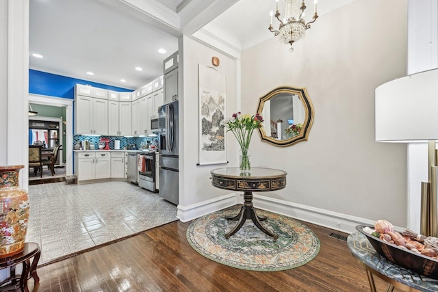 4914 S Washington Park Ct, Chicago, IL 60615 - foyer featuring a chandelier, wood finished floors, baseboards, and recessed lighting