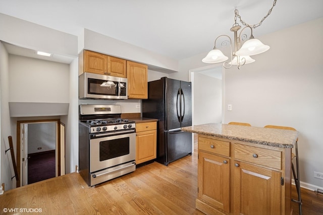 521 N Greenwood Dr, Palatine, IL 60074 - kitchen with stainless steel appliances, light wood-style flooring, hanging light fixtures, a kitchen island, and a chandelier