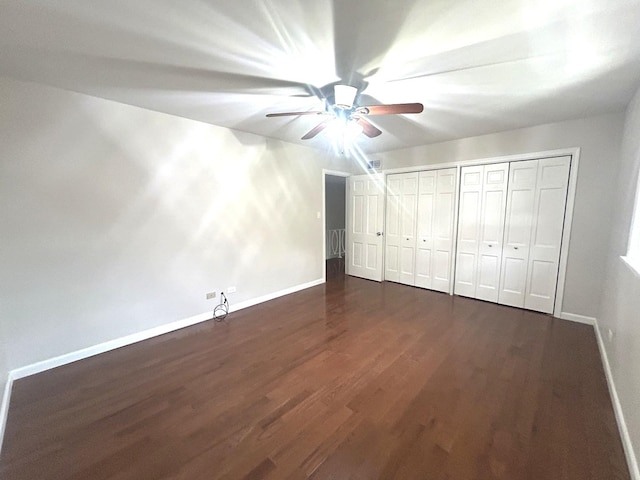 1402 Berry Ln, Flossmoor, IL 60422 - unfurnished bedroom with dark wood finished floors, baseboards, ceiling fan, and a closet