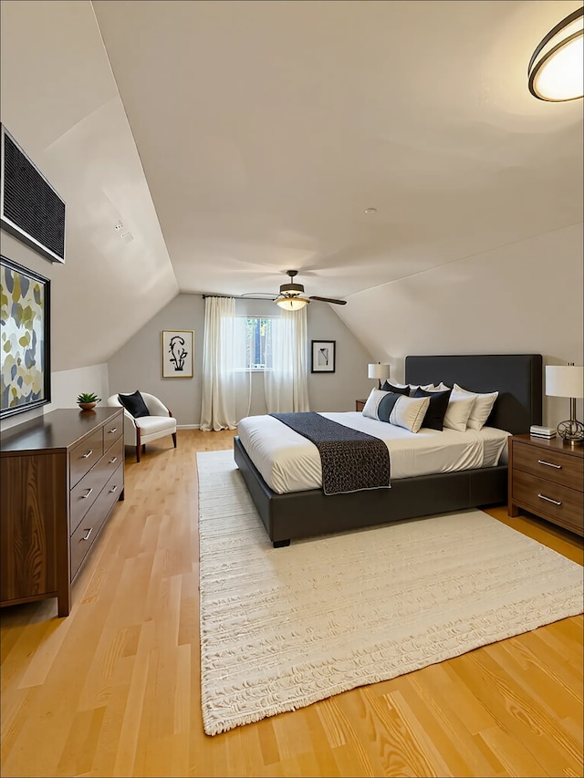 bedroom featuring light wood-style flooring, lofted ceiling, and a ceiling fan