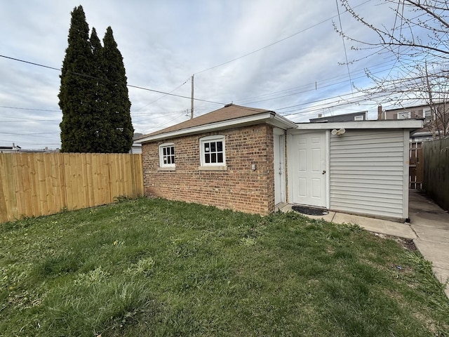 rear view of house with brick siding and an outbuilding