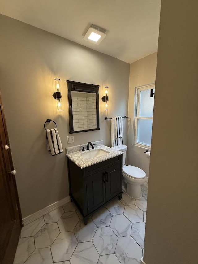 bathroom featuring toilet and vanity
