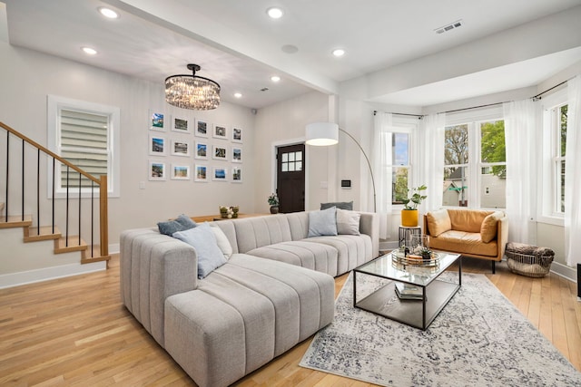 3104 N Sacramento Ave, Chicago, IL 60618 - living area with light wood-style flooring, stairs, recessed lighting, baseboards, and a chandelier