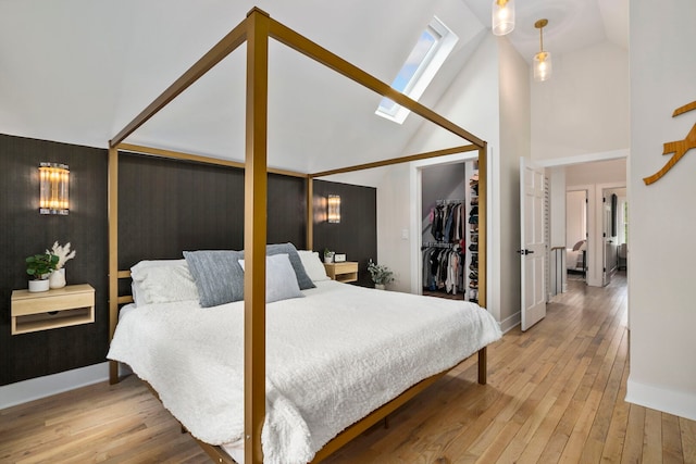 3104 N Sacramento Ave, Chicago, IL 60618 - bedroom with light wood-type flooring, a skylight, baseboards, and high vaulted ceiling