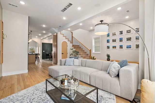 3104 N Sacramento Ave, Chicago, IL 60618 - living area with light wood-style floors, stairway, arched walkways, recessed lighting, and baseboards