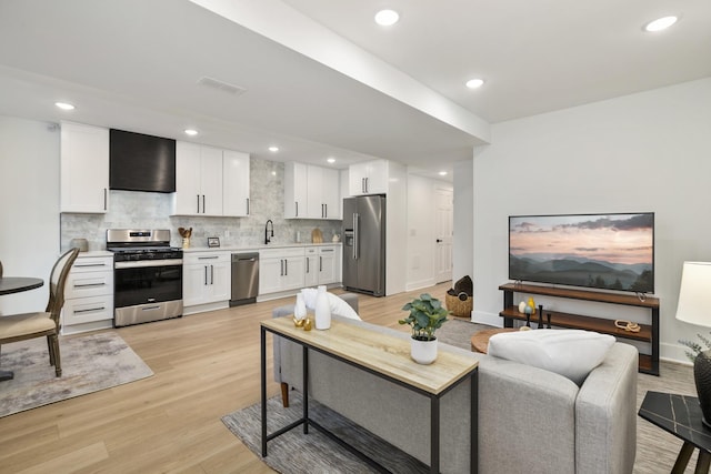 3104 N Sacramento Ave, Chicago, IL 60618 - living room featuring light wood-style floors, recessed lighting, and baseboards