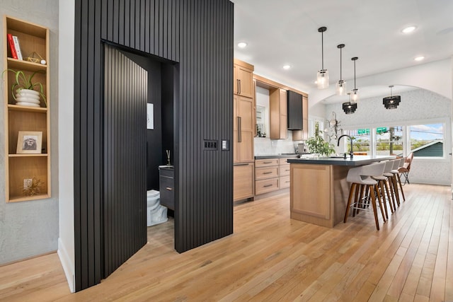 3104 N Sacramento Ave, Chicago, IL 60618 - kitchen with light wood-type flooring, light brown cabinetry, a center island with sink, paneled built in fridge, and recessed lighting