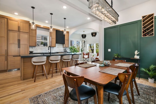 3104 N Sacramento Ave, Chicago, IL 60618 - dining area featuring light wood-type flooring, recessed lighting, a chandelier, and arched walkways