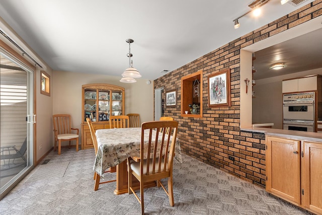 7009 W 115th Pl, Worth, IL 60482 - dining area with brick wall, light carpet, and an accent wall