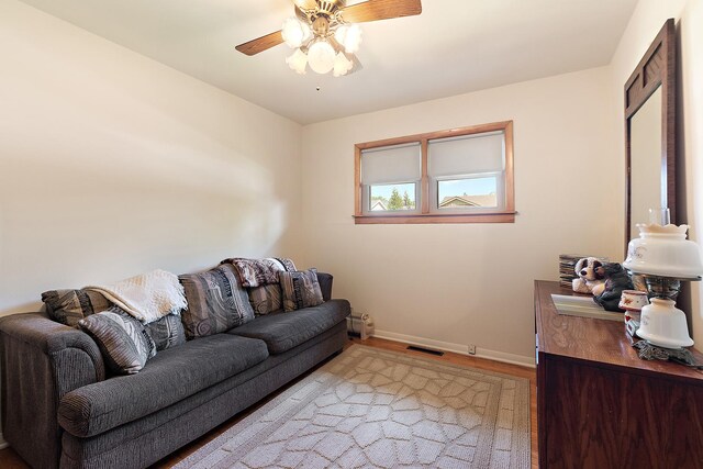 7009 W 115th Pl, Worth, IL 60482 - living room with baseboards, a ceiling fan, and light wood-type flooring