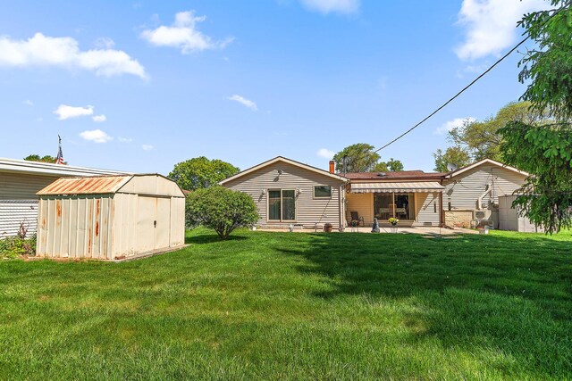 7009 W 115th Pl, Worth, IL 60482 - back of property with a shed, a patio, an outbuilding, and a lawn