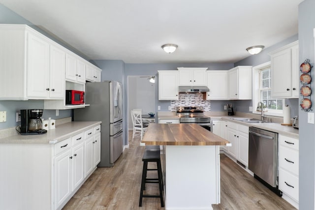 1505 Torrey Pines Rd, Normal, IL 61761 - kitchen featuring stainless steel appliances, a sink, wood counters, under cabinet range hood, and a ceiling fan