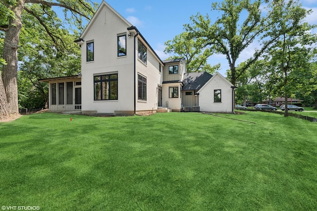 1107 Quassey Ave, Lake Bluff, IL 60044 - rear view of property with a sunroom and a yard