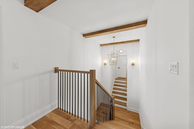 1107 Quassey Ave, Lake Bluff, IL 60044 - staircase with beamed ceiling, wood finished floors, and a chandelier