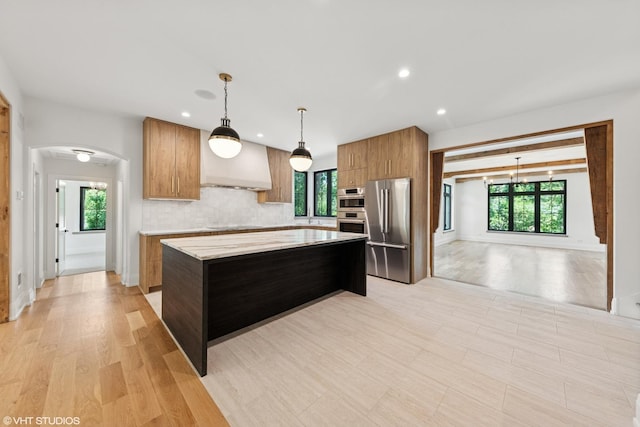 1107 Quassey Ave, Lake Bluff, IL 60044 - kitchen with appliances with stainless steel finishes, arched walkways, brown cabinetry, healthy amount of natural light, and recessed lighting