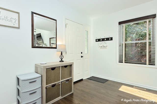 entryway featuring dark wood-style floors and baseboards