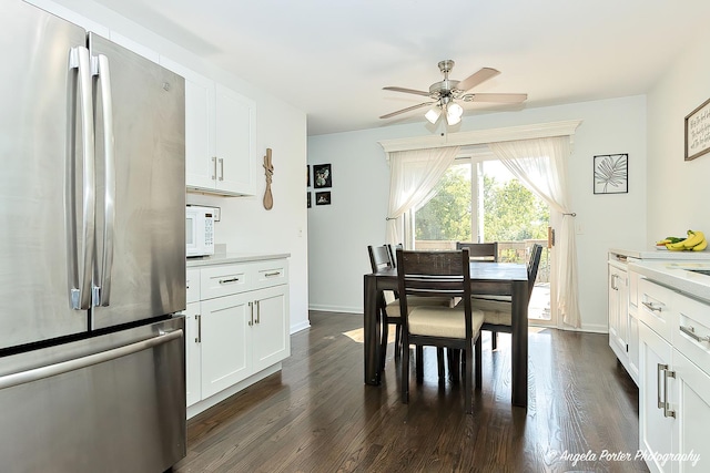 dining room featuring a ceiling fan, dark wood-type flooring, and baseboards