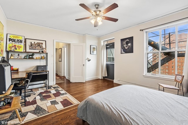 4940 S E End Ave Unit 17A, Chicago, IL 60615 - bedroom featuring wood finished floors, a desk, multiple windows, and a ceiling fan