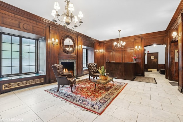 4940 S E End Ave Unit 17A, Chicago, IL 60615 - living room featuring wooden walls, a chandelier, radiator, a high end fireplace, and light tile patterned floors