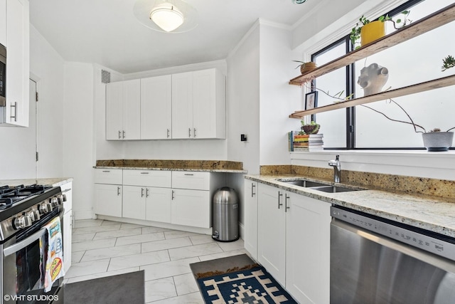 4940 S E End Ave Unit 17A, Chicago, IL 60615 - kitchen featuring stainless steel appliances, white cabinetry, light stone countertops, and crown molding