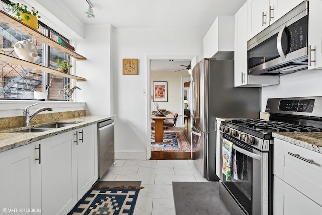 4940 S E End Ave Unit 17A, Chicago, IL 60615 - kitchen featuring appliances with stainless steel finishes, light marble finish floors, white cabinets, light stone countertops, and a ceiling fan