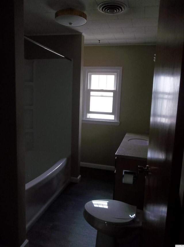 1619 Locust, Quincy, IL 62301 - bathroom with toilet, vanity, baseboards, and bathtub / shower combination