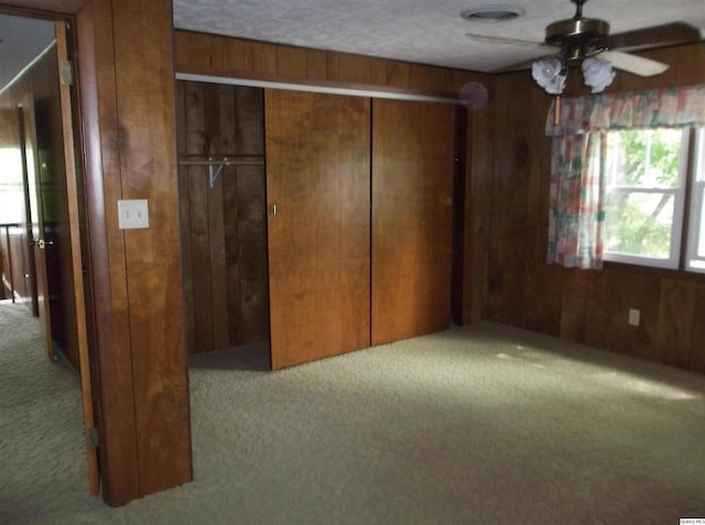 1619 Locust, Quincy, IL 62301 - unfurnished bedroom with carpet floors, wood walls, and a closet