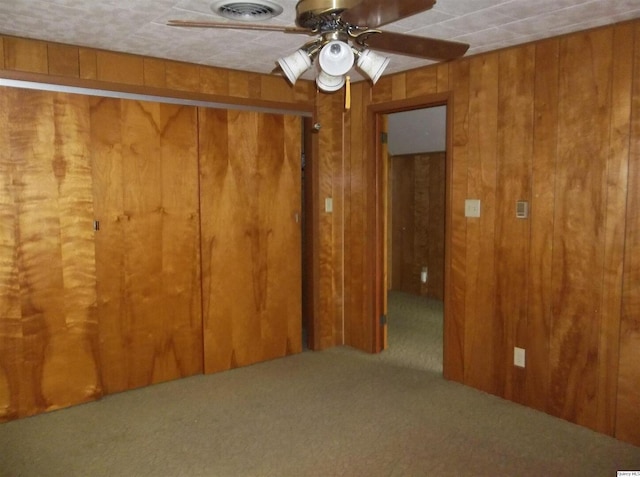 1619 Locust, Quincy, IL 62301 - carpeted spare room featuring a ceiling fan and wooden walls