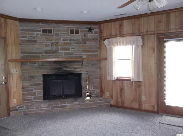 1619 Locust, Quincy, IL 62301 - unfurnished living room featuring wood walls, a fireplace, ceiling fan, ornamental molding, and carpet