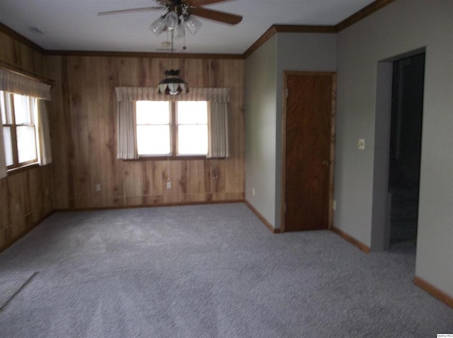 1619 Locust, Quincy, IL 62301 - unfurnished room featuring a ceiling fan, wood walls, ornamental molding, carpet, and baseboards