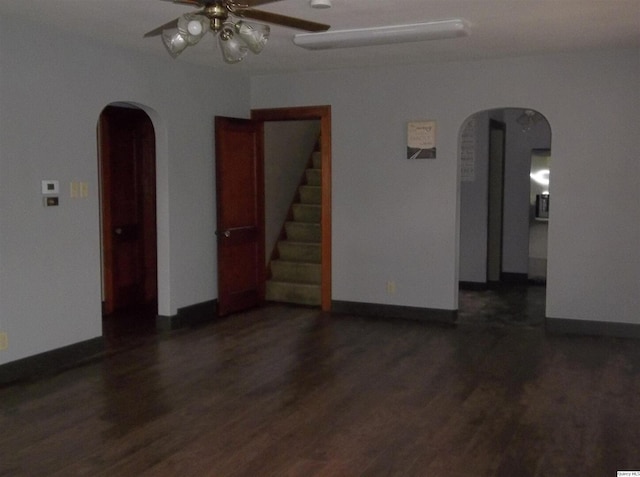 1619 Locust, Quincy, IL 62301 - spare room featuring arched walkways, a ceiling fan, dark wood-type flooring, and baseboards