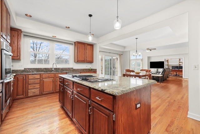 625 Fielding Place Ct, Barrington, IL 60010 - kitchen with stovetop with downdraft, light wood-style flooring, a center island, and hanging light fixtures