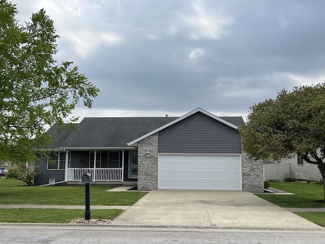 330 Centerpoint Dr, Bourbonnais, IL 60914 - single story home with concrete driveway, covered porch, a front lawn, an attached garage, and brick siding