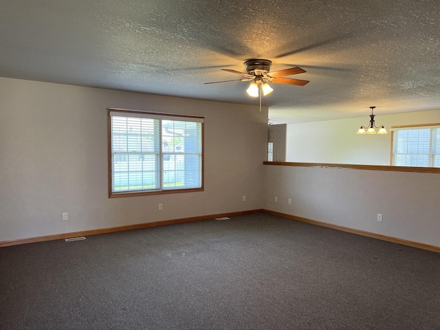 330 Centerpoint Dr, Bourbonnais, IL 60914 - carpeted empty room with a chandelier, ceiling fan, baseboards, and a textured ceiling