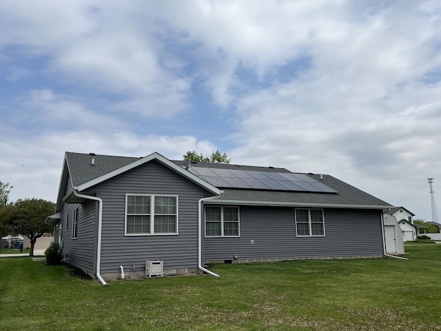 330 Centerpoint Dr, Bourbonnais, IL 60914 - rear view of house featuring solar panels, a yard, and roof with shingles