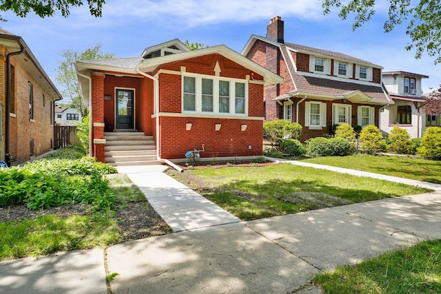 1115 N Taylor Ave, Oak Park, IL 60302 - view of front of home with brick siding, a chimney, and a front yard