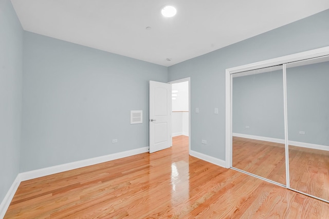 1115 N Taylor Ave, Oak Park, IL 60302 - unfurnished bedroom with light wood-style floors, baseboards, and a closet
