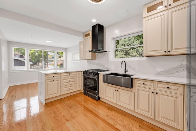 1115 N Taylor Ave, Oak Park, IL 60302 - kitchen featuring black range with gas stovetop, wall chimney range hood, a sink, a peninsula, and plenty of natural light