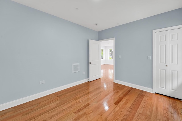 1115 N Taylor Ave, Oak Park, IL 60302 - unfurnished bedroom with light wood-style floors, baseboards, and a closet